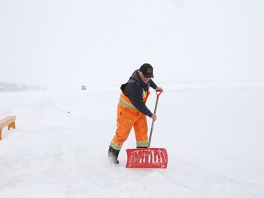 Al Thibeault, of Candu Construction, shovels a section of ice at the Ramsey Lake skating path in Sudbury, Ont. on Monday February 22, 2021. Environment Canada said Greater Sudbury can expect a 40 per cent chance of flurries or rain showers with a high of 4 C on Tuesday. John Lappa/Sudbury Star/Postmedia Network
