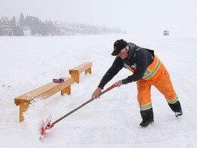 Al Thibeault, of Candu Construction, shovels a section of ice at the Ramsey Lake skating path in Sudbury, Ont. on Monday February 22, 2021. Environment Canada said Greater Sudbury can expect a 40 per cent chance of flurries or rain showers with a high of 4 C on Tuesday. John Lappa/Sudbury Star/Postmedia Network