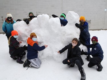 Grade 6 students at Ecole St-Denis work on a snow sculpture at the school in Sudbury, Ont. on Tuesday February 23, 2021. Students took advantage of the fresh snow to build sculptures and snow people around school grounds. John Lappa/Sudbury Star/Postmedia Network