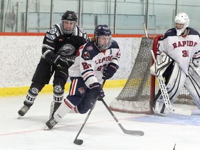 French River Rapids forward Cooper Bowman (27) carries the puck past netminder Ben Montgomery (31) while Espanola Express forward Gavin Graham (2) gives chase during first-period NOJHL action at Noelville Community Centre on Tuesday, February 23, 2021. Ben Leeson/The Sudbury Star/Postmedia Network