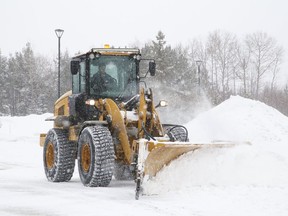 Snow is removed from the Science North parking lot on Feb. 24.