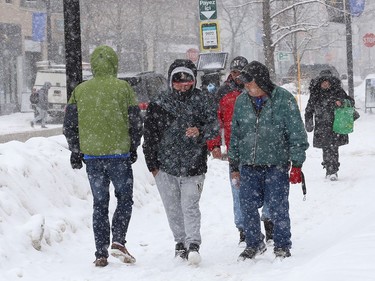 Pedestrians navigate a snow-covered sidewalk on Durham Street in Sudbury, Ont. on Wednesday February 24, 2021. Environment Canada said Greater Sudbury can expect sunny skies with a high of -6 C on Thursday. Wind chill -23 C in the morning and -8 C in the afternoon. John Lappa/Sudbury Star/Postmedia Network