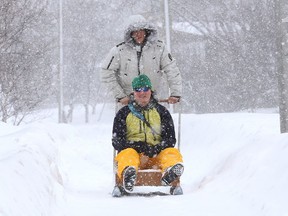 Maximilien Deschenes-Chitov, standing, and Soren Howald test a sled they made in Sudbury, Ont. on Wednesday February 24, 2021.