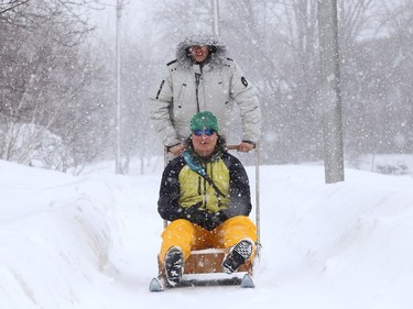 Maximilien Deschenes-Chitov, standing, and Soren Howald test a sled they made in Sudbury, Ont. on Wednesday February 24, 2021. John Lappa/Sudbury Star/Postmedia Network