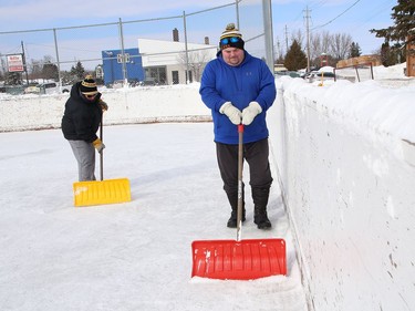 Stacy Paajanen and her husband, Kurt, help to maintain the ice at the Sixth Avenue Playground in Lively, Ont. on Thursday February 25, 2021. John Lappa/Sudbury Star/Postmedia Network