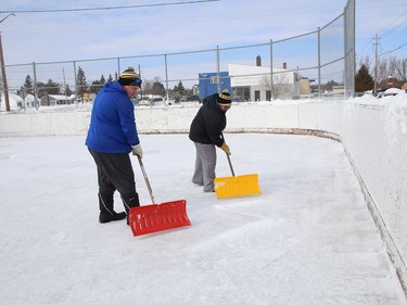 Stacy Paajanen and her husband, Kurt, help to maintain the ice at the Sixth Avenue Playground in Lively, Ont. on Thursday February 25, 2021. John Lappa/Sudbury Star/Postmedia Network