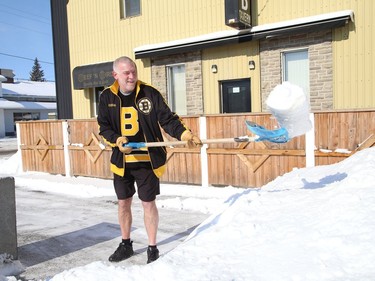 The cold didn't seem to bother Anthony Toppazzini, of the Beef 'N Bird on Lorne Street in Sudbury, Ont., as he shovelled while wearing his shorts on Thursday February 25, 2021. John Lappa/Sudbury Star/Postmedia Network