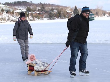 Alex and Sophie Duguay go for a skate with their daughter Noemi, 7 months, in tow, at the Ramsey Lake skating path in Sudbury, Ont. on Friday February 26, 2021. John Lappa/Sudbury Star/Postmedia Network