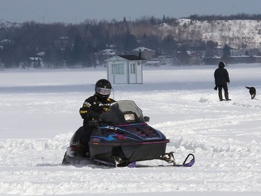 A snowmobile travels across Ramsey Lake in Sudbury, Ont. on Friday February 26, 2021. John Lappa/Sudbury Star/Postmedia Network