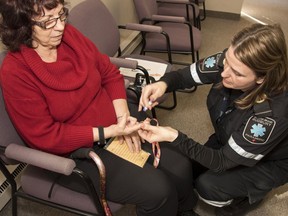 A patient of the community paramedic health promotion clinic has her blood sugar level checked. The provincial government on Tuesday said it will give $6.5 million to a paramedicine program in Sudbury that keeps seniors in their homes longer and out of hospital and long-term care homes.Mary Katherine Keown/The Sudbury Star