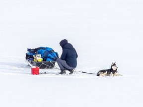 A man and his Husky ice fishing on Wednesday Jan. 20, 2021.

Derek Ruttan/Postmedia Network