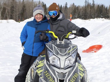 Snowmobiling buds Seb Larocque, left, and Max Zelionka taking a break near the Timmins sliding hill on Monday.

RICHA BHOSALE/The Daily Press