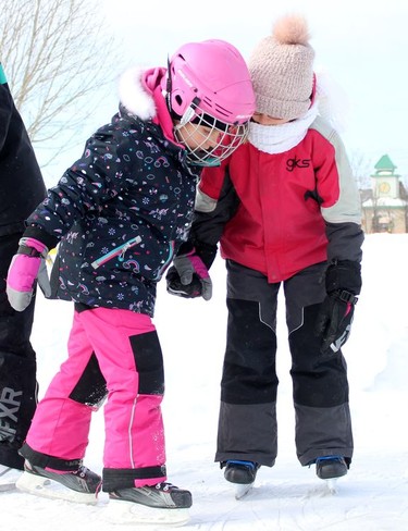 Emma Lessard, left, holds hands with her cousin, Ellie Therrien, at the Hollinger Skating Path on Monday as they were out with their other family members to enjoy Family Day.

RICHA BHOSALE/The Daily Press