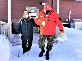 Sgt. Matthew Gull, a commander with the Canadian Rangers, helps Elder Elizabeth Koostachin, 86, get to  her COVID vaccination in Peawanuck.

Supplied/Master Cpl. Pamela Chookomoolin, Canadian Rangers
