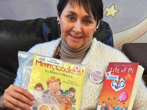 CEO Christina Blazecka shows off two books from Canadian authors during their “I read Canada” contest.TP.jpg