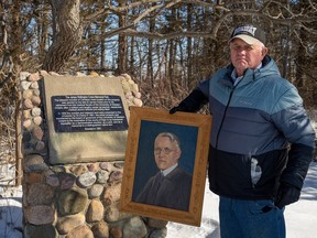 Jim Crane is outraged after land near Iona Station originally donated by his late great uncle, James Crane, was sold off by the local conservation authority. He's pictured next to a memorial cairn on the land, and holding an oil painting of James Crane, a doctor, teacher and conservationist who planted trees on the seven-acre property in the 1930s. Max Martin/Postmedia Network