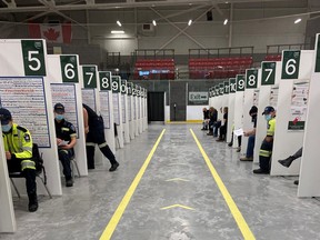 Bruce County paramedics prepare to receive the COVID-19 vaccine inside the Grey Bruce Health Unit's "hockey hub" and mass-immunization centre in Hanover at the P&H Centre in this file photo. Photo supplied by Bruce County.