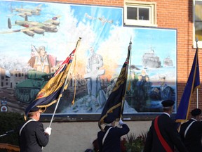 The mural attached to 583 Berford St. next to the cenotaph in Wiarton shown here during a Remembrance Day ceremony in 2015. Wiarton Echo file photo.