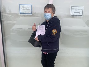 McMurray Métis elder Anne Michalko poses with her vaccination certificate after getting a COVID-19 vaccine in Fort McMurray on Feb. 25, 2021. Image courtesy of Melanie Walsh