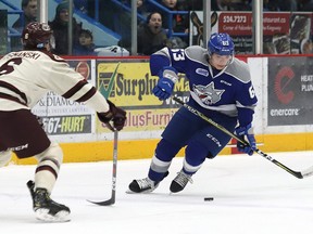 Liam Ross, right, of the Sudbury Wolves, attempts to skate around Austin Osmanski, of the Peterborough Petes, during OHL action at the Sudbury Community Arena in Sudbury, Ont. on Friday January 25, 2019.