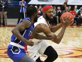 Dexter Williams Jr., right, of the Sudbury Five, drives to the basket during basketball action against KW Titans at the Sudbury Community Arena in Sudbury, Ont. on Thursday December 12, 2019.
