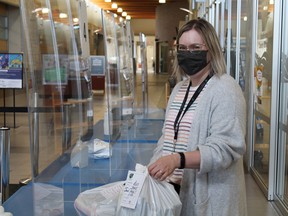 Library staff member Cindy Teufeld puts out items to be picked up by patrons through a contactless pickup system that the library has been using since its doors were shut by provincial mandate in December 2020. Following the province's Stage 2 reopening announcement, the library will begin browse and go service on Tuesday, March 16 at noon. Photo Supplied