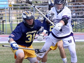 Kyle Patterson (31) of the Laurentian Voyageurs battles Cody Ward (14) of the Western Mustangs during Canadian University Field Lacrosse Association action at Laurentian University in Sudbury, Ontario on Saturday, September 21, 2019.