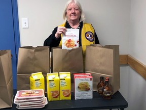 Donna Arkwright of the Powassan Lions Club is ready to pack some of the Do-It-Yourself Pancake Breakfast items together. The non-perishable items can be packed now, while the perishable food goods will be handled on pick-up day..
Sue Oshell Photo