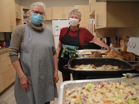 Sally Kendall, left, and Sallie Hunt show off a meal they made for the warming space at the First Presbyterian Church.