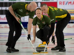 Northern Ontario skip Brad Jacobs releases a stone to his front end, lead Ryan Harnden (left) and second E.J.Harnden, during Draw 14 against Manitoba during Brier action Wednesday in Calgary. Curling Canada/ Michael Burns