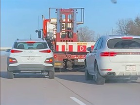 A Hyundai Kona and a Porsche driving recklessly on Highway 401 Tuesday afternoon. (Sarah Young/Supplied Photo)