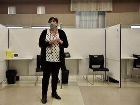 Mary Van Den Neucker, program manager for Southwestern public health, said there are 24 vaccination “pods” or stations at Woodstock’s Goff Hall vaccination site. They were designed to be easily turned over and disinfected as people move through the vaccination process. (Kathleen Saylors/Woodstock Sentinel-Review)