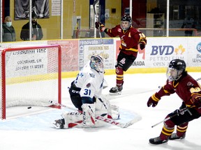 Josh Dickson, background, and Zach Smith celebrate Smith’s first-period shorthanded goal during Saturday night’s NOJHL game at the Tim Horton Event Centre in Cochrane while the puck bounces out of the net behind Crunch goalie Liam McCarthy. Smith would add a second shorthanded marker and set up a pair of goals to help lead the Rock to a 9-4 win over the Crunch in the second game of their 10-game set. THOMAS PERRY/THE DAILY PRESS