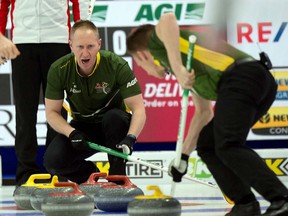 Northern Ontario skip Brad Jacobs sits in the rings as third Marc Kennedy brings the stone into the house during Brier championship pool play against Team Canada Friday in Calgary. Curling Canada/ Michael Burns Photo