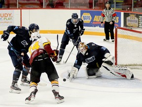 Timmins Rock forward Nicolas Pigeon pounces on a juicy rebound in front of Crunch goalie Liam McCarthy as Cochrane defenders Liam Boswell, left, and Travis Szafron look on during the second period of Tuesday night’s NOJHL game at the McIntyre Arena. Pigeon scored on the play to give the Rock a 3-1 lead in a game they would go on to win 9-1. The two sides will meet again at the Tim Horton Event Centre in Cochrane on Friday, at 8 p.m. THOMAS PERRY/THE DAILY PRESS