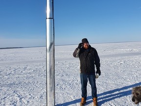 Hugo Couët stands beside Cold Lake's monolith, which he and his wife noticed while out walking their dogs. PHOTO BY ALICIA Couët