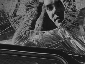 A photo by John McNeill, taken after an encounter in 1958 between a car and telephone pole at the corner of Worthington and Fraser streets. The man removing pieces of windshield is Emmett Watters, a community member involved with Air Cadets who worked at the local outdoors store, Lefebvre's. Supplied Photo