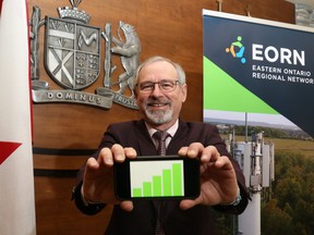 Jim Pine, a team member of the Eastern Ontario Regional Network and chief administrative officer of Hastings County, holds his mobile phone in the council chamber Friday in Belleville. The network has new a deal with Rogers Communications Inc. to expand wireless service to an estimated 99 per cent of the region.