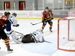 Timmins Rock forward Josh Dickson, right, watches as his one-timer bounces off the twine behind Crunch goalie Michael Nickolau during the second period of Sunday afternoon’s NOJHL game at the Tim Horton Event Centre in Cochrane. Dickson’s first of two goals on the night and 10th of the season proved to be the game-winner as the Rock went on to beat the Crunch 6-1. The two sides will play the seventh game of their 10-game set at the Tim Horton Event Centre on Wednesday, at 6:30 p.m. THOMAS PERRY/THE DAILY PRESS