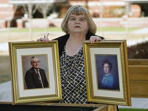 Lynda Stewart holds a photo of her father Lowell Stewart and her mother Jean Stewart outside her home in Sherwood Park, on Friday, March 19. Both of her parents died from COVID-19. Lynda also contracted the coronavirus and almost died but has since recovered. LARRY WONG/Postmedia