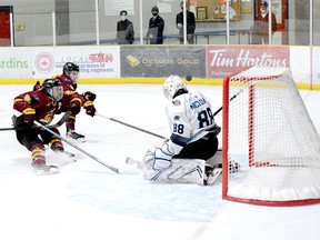 Timmins Rock captain Derek Seguin, left, and blue-liner Evan Beaudry apply the brakes as the puck sails over the shoulder of Crunch goalie Michael Nickolau but over the crossbar, as well, during Wednesday night’s NOJHL game at the Tim Horton Event Centre in Cochrane. The Rock went on to defeat the Crunch 5-2 for their sixth victory in seven tries against the East Division rivals this season. The two sides will play their eighth game at the McIntyre Arena on Thursday, at 8:30 p.m. THOMAS PERRY/THE DAILY PRESS