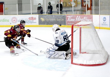 Timmins Rock captain Derek Seguin, left, and blue-liner Evan Beaudry apply the brakes as the puck sails over the shoulder of Crunch goalie Michael Nickolau but over the crossbar, as well, during Wednesday night’s NOJHL game at the Tim Horton Event Centre in Cochrane. The Rock went on to defeat the Crunch 5-2 for their sixth victory in seven tries against the East Division rivals this season. The two sides will play their eighth game at the McIntyre Arena on Thursday, at 8:30 p.m. THOMAS PERRY/THE DAILY PRESS