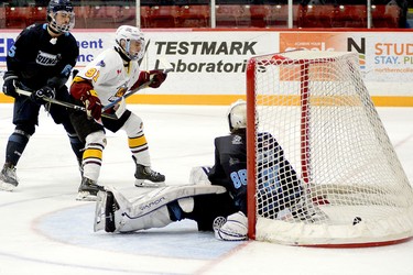 Timmins Rock captain Derek Seguin deposits his NOJHL-leading 23rd goal of the season into the Crunch net behind Cochrane goalie Michael Nickolau during the second period of Tuesday night’s NOJHL game at the McIntyre Arena. Seguin, who was playing his final game in a Rock uniform, picked up two points on the night to earn a share of the NOJHL scoring title. The Rock went on to blank the Crunch 3-0. THOMAS PERRY/THE DAILY PRESS