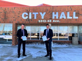 Cold Lake Mayor Craig Copeland (left) and Municipal District of Bonnyville Reeve Greg Sawchuk pose for a photo with copies of the ratified Intermuncipal Collaboration Framework outside Cold Lake City Hall. PHOTO BY CITY OF COLD LAKE