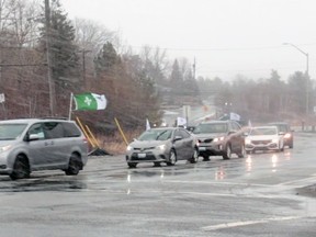 Vehicles adorned with flags and banners approach Laurentian University on Sunday afternoon to show support for the institution and pressure the provincial government to provide the school with financial support.