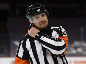 Referee Tim Peel is shown during an NHL hockey game between the Philadelphia Flyers and the New York Islanders in Philadelphia, in this Saturday, Jan. 30, 2021, file photo. Tim Peel's career as an NHL referee is over after his voice was picked up by a TV microphone saying he wanted to call a penalty against the Nashville Predators. The league on Wednesday, March 24, 2021, announced that Peel “no longer will be working NHL games now or in the future.” The 54-year-old Peel had already made plans to retire next month.
