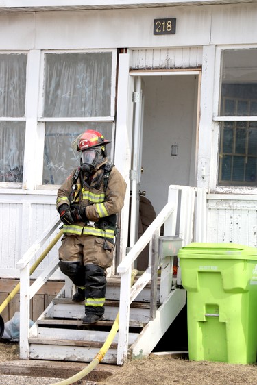 A firefighter responds to a blaze at 218 Gloucester St., in Sault Ste. Marie, Ont., on Tuesday, March 30, 2021.  (BRIAN KELLY/THE SAULT STAR/POSTMEDIA NETWORK)