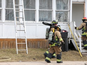 Firefighter respond to a blaze at 218 Gloucester St., in Sault Ste. Marie, Ont., on Tuesday, March 30, 2021.  (BRIAN KELLY/THE SAULT STAR/POSTMEDIA NETWORK)