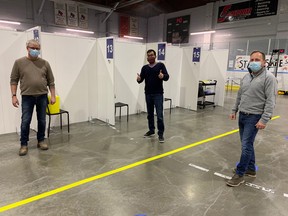 L-R: Rick McMurray, Site Services, Bruce Power, Dr. Sudit Ranade, Medical Officer of Health, Lambton Public Health and Bill Whetstone, Supply Chain, Bruce Power, stand at the "Hockey Hub" which was set up at the Point Edward Memorial Arena in Lambton County, with Bruce Powers help. SUBMITTED