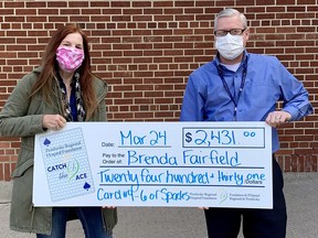 Brenda Fairfield was the week #5 winner of the Pembroke Regional Hospital Foundation's Catch the Ace online progressive jackpot lottery. She is presentd with her prize by PRHF executive director Roger Martin.
